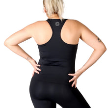 Load image into Gallery viewer, Back of a woman wearing black activewear leggings and a black racer back style top with a small white logo in the upper middle back.
