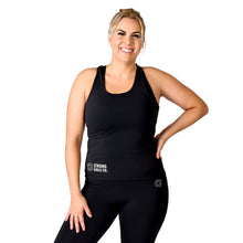 Load image into Gallery viewer, Front facing smiling woman, wearing black activewear leggings with a small logo on the left hip with a matching black top with a logo and the words Strong Girls Co. on the bottom right side, and white training shoes
