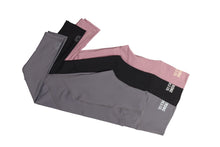 Load image into Gallery viewer, Three pairs of activewear leggings with pockets, grey, black and pink, laid flat and folded, overlapping each other with small logos on one ankle of each pair and partial logos showing on the back middle waist band.
