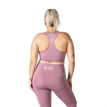 Load image into Gallery viewer, Back facing woman wearing pink activewear leggings with a logo on the back middle waistband with the words Strong Girls Co., a matching pink crop top with a logo on the back middle upper with the words Strong Girls Co.
