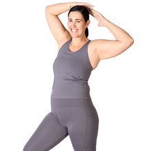 Load image into Gallery viewer, Front facing smiling woman, wearing grey activewear leggings with pockets with a matching grey top with a logo and the words Strong Girls Co. on the bottom right side.
