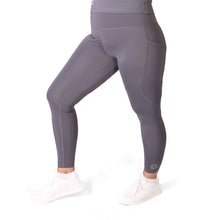 Load image into Gallery viewer, Side facing woman wearing full length grey activewear leggings with pockets with a small logo on the left side ankle, a matching grey  top and white training shoes
